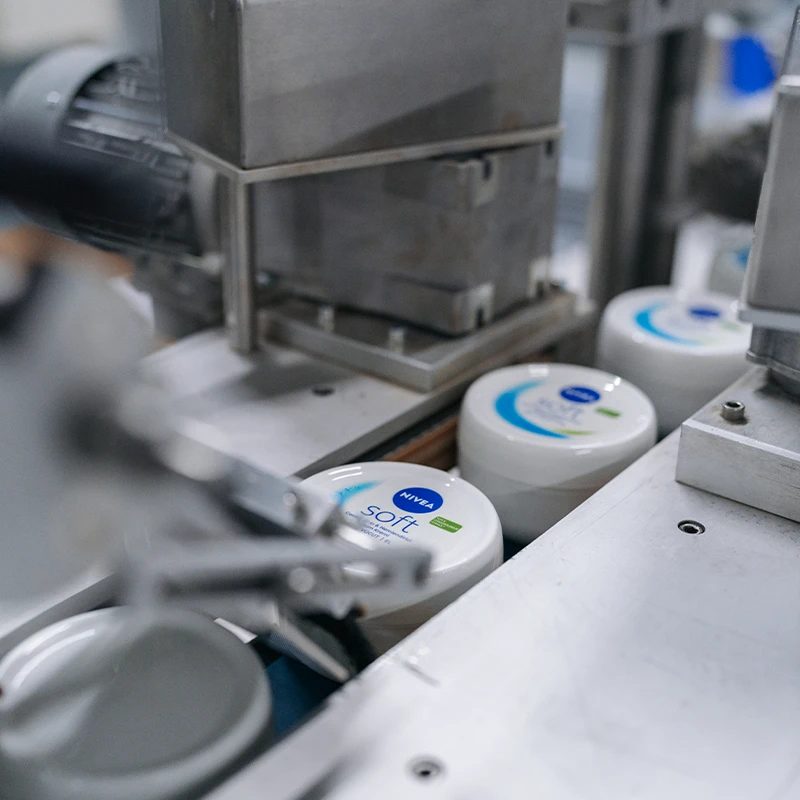 In the image, there is a machine that is producing Nivea skin creams. (photo)